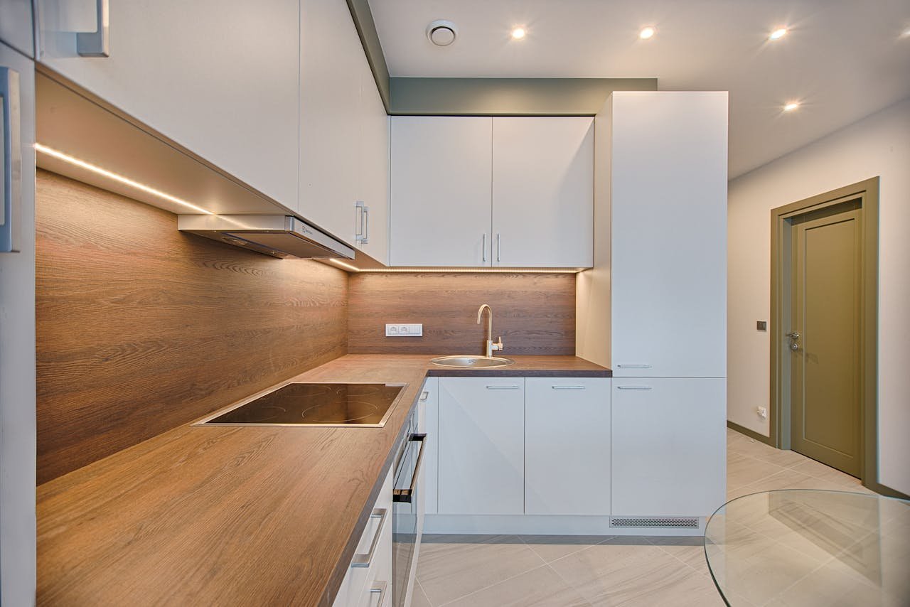 why-choose-us Modern kitchen interior with minimalistic design and wooden accents, captured with natural lighting.